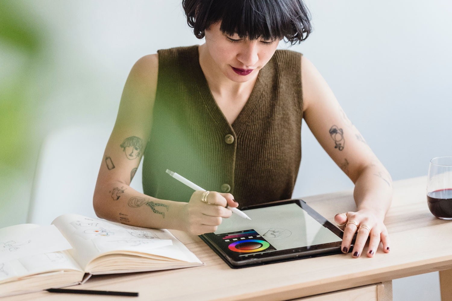 Woman drawing on tablet with stylus.